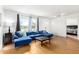 Bright living room featuring a large window with views and stylish blue sectional sofa at 7810 N 47Th Ave, Glendale, AZ 85301