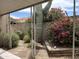 Charming backyard featuring a large cactus, vibrant flowering bushes, and decorative landscaping at 7837 E Crestwood Way, Scottsdale, AZ 85250