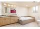 Updated bathroom with a built-in bathtub and a large vanity at 7837 E Crestwood Way, Scottsdale, AZ 85250