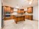 Spacious kitchen with wood cabinets, granite countertops, and island at 7837 E Crestwood Way, Scottsdale, AZ 85250