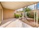 Covered patio with tile flooring, desert landscaping, and a large cactus at 7837 E Crestwood Way, Scottsdale, AZ 85250