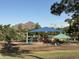 Community playground with vibrant play structures, shaded picnic area, and mountain views on a sunny day at 7837 E Crestwood Way, Scottsdale, AZ 85250