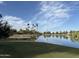 Scenic pond view with palm trees reflecting in the water on a sunny day in a beautiful community at 7837 E Crestwood Way, Scottsdale, AZ 85250