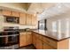 Modern kitchen with stainless steel appliances and wood cabinets at 8019 N 14Th St, Phoenix, AZ 85020