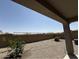 Backyard featuring gravel, privacy walls, minimal foliage and a covered patio area at 8297 W Rushmore Way, Florence, AZ 85132