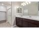 Double vanity bathroom with a large mirror and shower at 8297 W Rushmore Way, Florence, AZ 85132