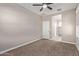 Well-lit bedroom featuring ceiling fan and closet at 8297 W Rushmore Way, Florence, AZ 85132