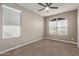 Bright bedroom with ceiling fan, window blinds, and carpet at 8297 W Rushmore Way, Florence, AZ 85132