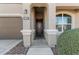 Front entry with dark brown door and stone flooring at 8297 W Rushmore Way, Florence, AZ 85132