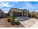 One-story house with brown garage door and landscaped yard at 8297 W Rushmore Way, Florence, AZ 85132