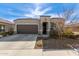 One-story house with brown garage door and landscaped yard at 8297 W Rushmore Way, Florence, AZ 85132