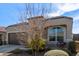 One-story house with brown garage door and landscaped yard at 8297 W Rushmore Way, Florence, AZ 85132