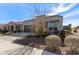 One-story house with brown garage door and landscaped yard at 8297 W Rushmore Way, Florence, AZ 85132