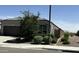 Street view of single-story home with desert landscaping, a private fence and grey paint at 8297 W Rushmore Way, Florence, AZ 85132