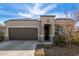 One-story house with brown garage door and landscaped yard at 8297 W Rushmore Way, Florence, AZ 85132