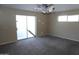 Large bedroom with carpet, sliding glass door, and ample natural light at 8643 S 16Th Pl, Phoenix, AZ 85042