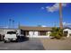 Single-story home with a large driveway and mature palm trees at 8643 S 16Th Pl, Phoenix, AZ 85042