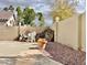 Backyard with a decorative rock waterfall, a concrete patio and lush landscaping at 9131 W Boca Raton Rd, Peoria, AZ 85381