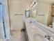 Bathroom with dual sinks, large mirrors, and a walk-in shower at 9131 W Boca Raton Rd, Peoria, AZ 85381