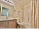 Bathroom featuring a single vanity, toilet and a shower-tub combo with curtain at 9131 W Boca Raton Rd, Peoria, AZ 85381