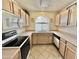 Bright kitchen with white appliances, tile floor and a window over the sink at 9131 W Boca Raton Rd, Peoria, AZ 85381