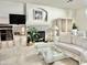 Cozy living room with fireplace, white sofa, glass table, and built-in shelves; a comfortable and inviting space at 9131 W Boca Raton Rd, Peoria, AZ 85381