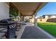 Backyard with grill, artificial turf and covered patio at 9625 E Spiral Ave, Mesa, AZ 85212