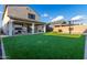 Artificial turf backyard with covered patio and basketball court at 9625 E Spiral Ave, Mesa, AZ 85212