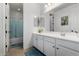 Simple bathroom with a tub, shower, and white vanity at 9625 E Spiral Ave, Mesa, AZ 85212