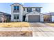 Two-story home with a gray-tone exterior, a large garage, and a well-manicured lawn at 9625 E Spiral Ave, Mesa, AZ 85212