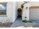 Front entrance with dark door, arched entryway, and brick walkway at 9625 E Spiral Ave, Mesa, AZ 85212