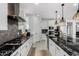 Modern kitchen with white cabinets, black countertops, and stainless steel appliances at 9625 E Spiral Ave, Mesa, AZ 85212