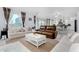 Open living area with brown leather recliner, white sofas, and view of kitchen at 9625 E Spiral Ave, Mesa, AZ 85212