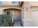 Front entry with a metal security door and mature shrubbery at 11625 W Jackson St, Avondale, AZ 85323