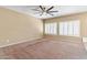 Living room with ceiling fan, neutral walls and carpet at 11625 W Jackson St, Avondale, AZ 85323