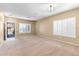 Spacious living room with neutral carpeting and plantation shutters at 11625 W Jackson St, Avondale, AZ 85323