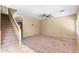 Living area with staircase, ceiling fan and carpet at 11625 W Jackson St, Avondale, AZ 85323