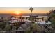 Stunning aerial view of a modern home with city views at sunset at 13801 N Moon Dr, Phoenix, AZ 85023