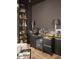 Home bar with dark cabinetry, granite countertop, and liquor shelving at 13801 N Moon Dr, Phoenix, AZ 85023