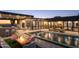 Luxury backyard oasis with a modern pool, fire pit, and city views at 13801 N Moon Dr, Phoenix, AZ 85023