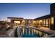 Stunning nighttime view of a modern pool and patio with city lights at 13801 N Moon Dr, Phoenix, AZ 85023