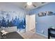 Bedroom with forest mural and built-in shelving at 14355 W Desert Hollow Dr, Surprise, AZ 85387