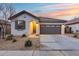 One-story home with attached garage and desert landscaping at 14355 W Desert Hollow Dr, Surprise, AZ 85387