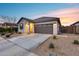 Front view of a one-story house with a two-car garage at 14355 W Desert Hollow Dr, Surprise, AZ 85387