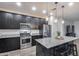 Modern kitchen with stainless steel appliances and island at 14355 W Desert Hollow Dr, Surprise, AZ 85387