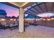 Cozy patio with fire pit, seating area, and pergola at 14355 W Desert Hollow Dr, Surprise, AZ 85387