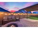 Relaxing patio with fire pit and seating area under pergola at 14355 W Desert Hollow Dr, Surprise, AZ 85387