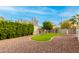 Landscaped backyard featuring a manicured lawn and drought-tolerant plants at 1451 E Ivanhoe St, Gilbert, AZ 85295