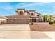 Two-story house with three-car garage, stone accents, and landscaped yard at 1451 E Ivanhoe St, Gilbert, AZ 85295