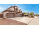 Two-story house with three-car garage, stone accents, and landscaped yard at 1451 E Ivanhoe St, Gilbert, AZ 85295